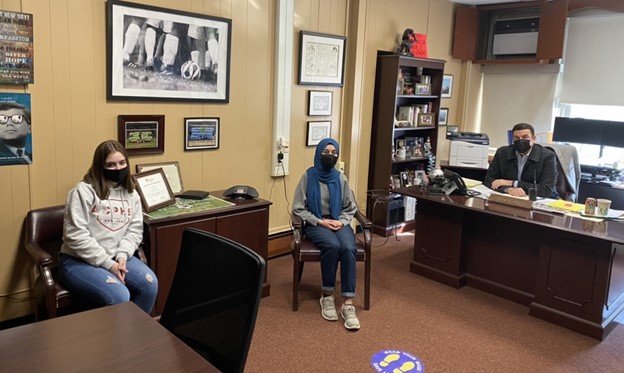 Nabihah Ahsan and Julia Spadaro, both seniors, interview Principal Callan in his office.