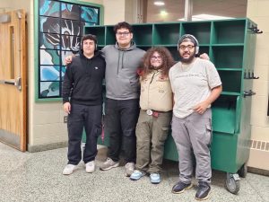 All four Brentwood seniors pose in front of Jayson Castros project. From left: Angel Rojas, Jayson Castro, Rudy Papa, and Tristan Whittaker.